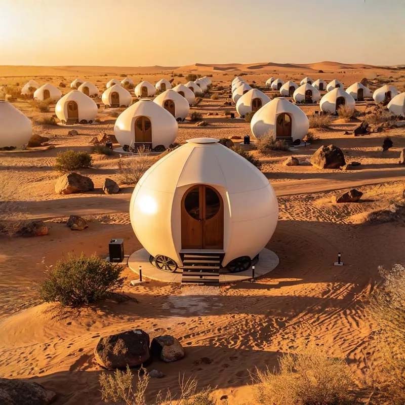 Trend Tents | Desert landscape with numerous white domed structures.